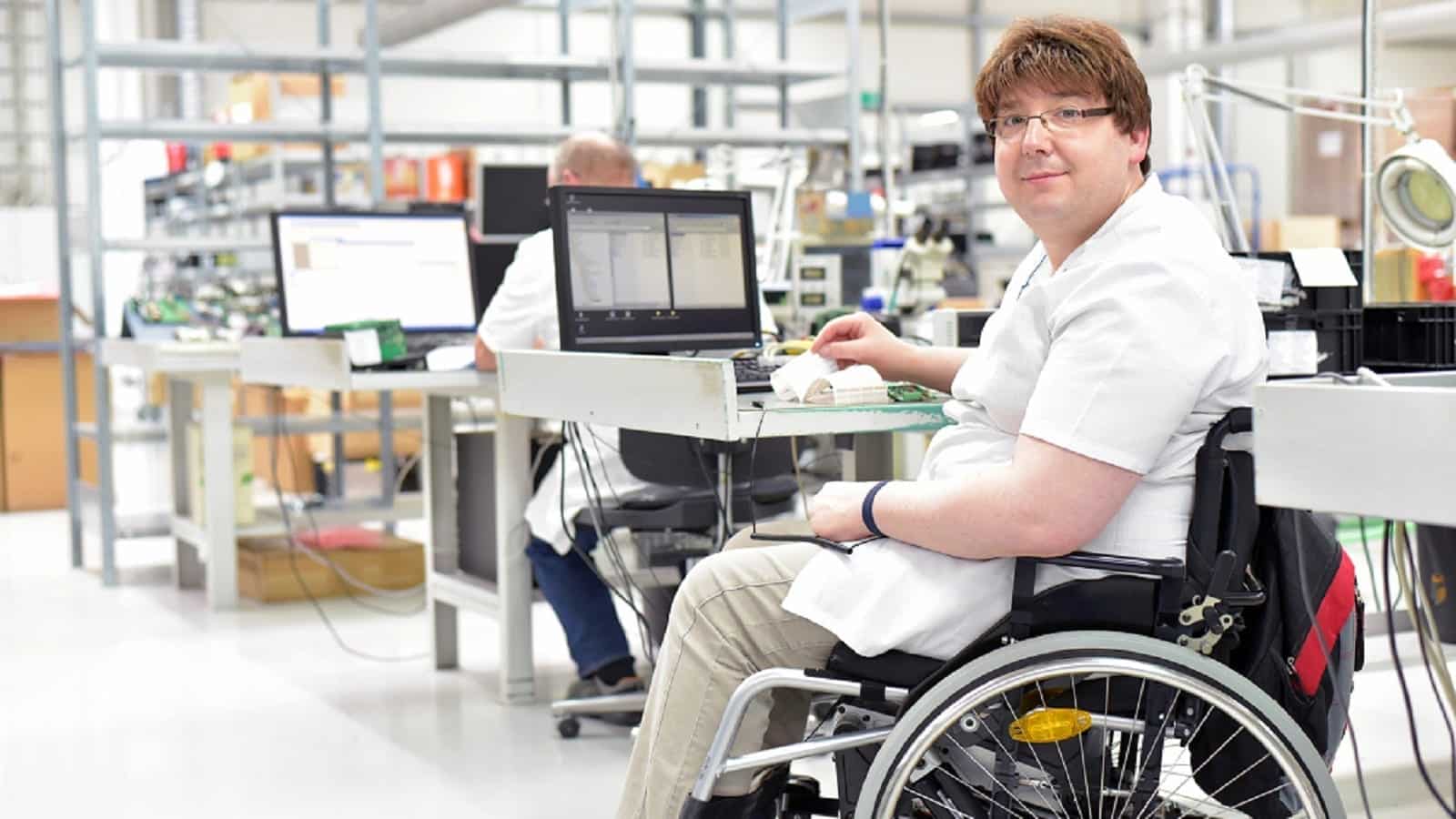 Handicapped Worker In A Wheelchair Stock Photo