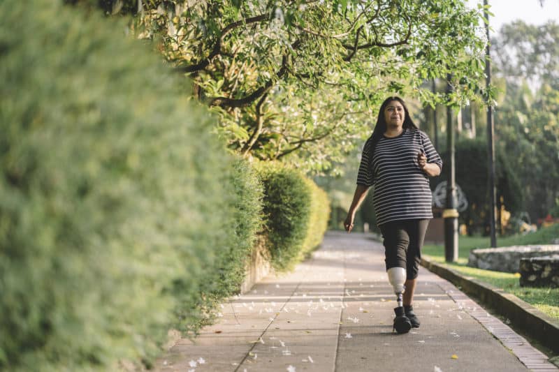 a disabled woman walking down the sidewalk in Los Angeles